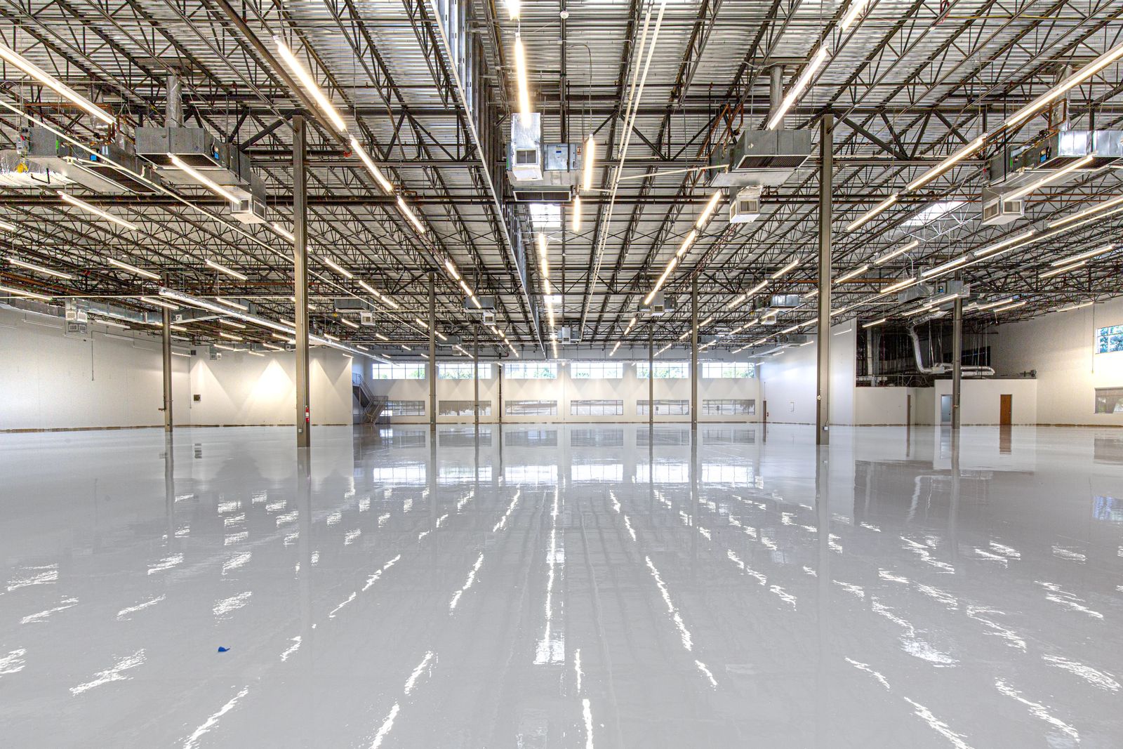 Glossy poured resin flooring in a modern industrial space