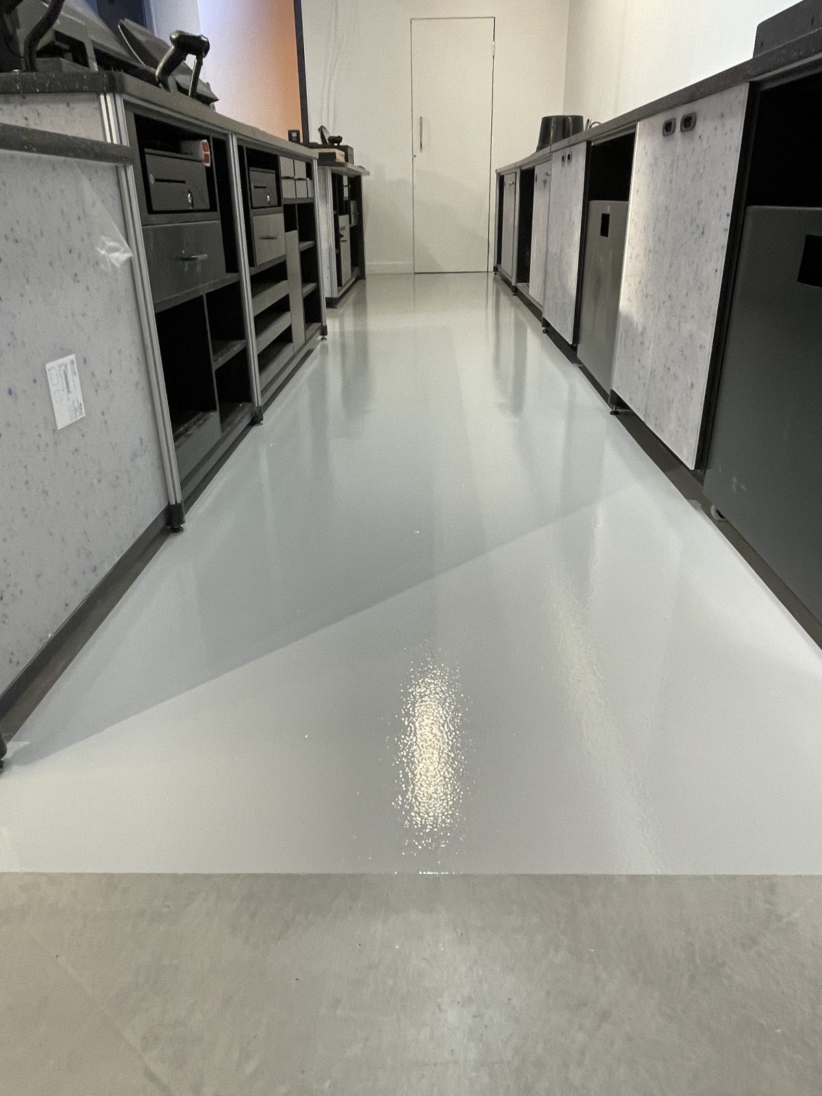 A high-gloss resin floor finish in a fitted-out unit
